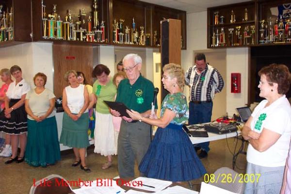 Eileen (Okolowicz) Webster Presenting Life Membership top Bill Owen
